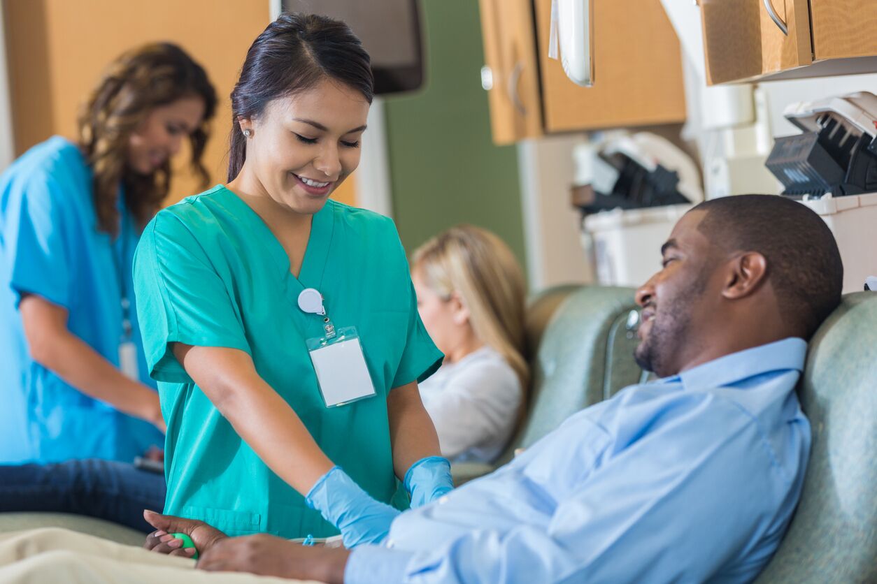 African American businessman donates blood during lunch break